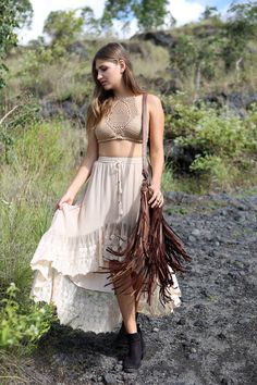 This soft figure loving crochet halter top is available in 4 gorgeous colours, beige, off white, magenta and black and have adjustable tie details at neck and waist. Style it with our high waisted Hunter Bloomers, or Savannah Lace Shorts or match it with our Hunter Crochet Skirt. Knitted of the softest rayon yarn we were able to source, these handmade Hunter Crochet Halter Tops are ideal for those afternoons spend on your favourite beach. SIZING Our model is 173 cm tall and wears a size SBelow n Bohemian Lace Crop Top For Beach, Bohemian Sleeveless Beige Halter Top, Beige Sleeveless Bohemian Halter Top, Bohemian Beige Halter Top For Vacation, Beige Sleeveless Bohemian Crop Top, Beige Halter Neck Crop Top For Vacation, Chic Crop Top With Crochet Trim For Beach, Brown Halter Neck Crop Top For Beach, Beige Triangle Halter Top For Vacation