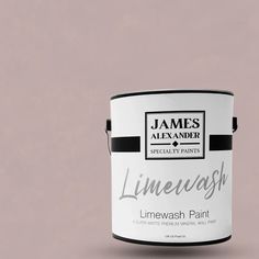 a white paint can with the words limewash painted on it's side, in front of a pink background