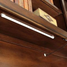 a close up of a shelf with books and other items on it's shelves