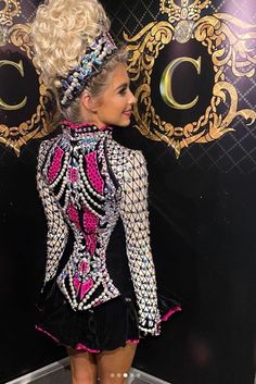 the back of a woman's dress with sequins and beads on it