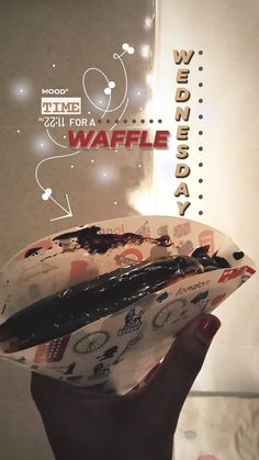 a person holding a piece of food in their hand with the words waffle on it