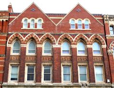 an old red brick building with arched windows