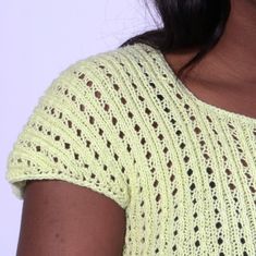 a close up of a woman wearing a yellow shirt