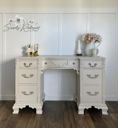 a white desk with two drawers and a vase on top