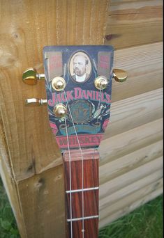 a guitar neck with an advertisement for jack daniels on it