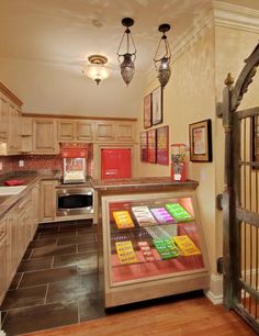 a kitchen filled with lots of counter top space next to a metal gated door