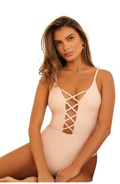 You'll be a true goddess in our caged front one-piece. Crisscross paneling teases the perfect amount of cleavage and moderate coverage will have you ready for beach volleyball. 82% Nylon 18% Spandex Made in Vietnam Triangle with criss cross front details Adjustable straps Moderate coverage Seamless Stretch Bodysuit With Crisscross Straps, Summer Strappy Bodysuit With Crisscross Straps, Fitted Bodysuit With Crisscross Straps, V-neck Swimming Bodysuit With Built-in Bra, V-neck Elastane Swimwear For Poolside, Dippin Daisy Swimwear, Pink V-neck One-piece Beachwear, Stretch V-neck One Piece Beachwear, Ballet Slippers