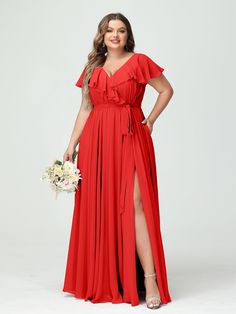 a woman in a long red dress posing for the camera with her hands on her hips