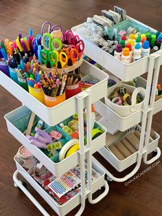 two white trays filled with craft supplies on top of a hard wood floor next to each other