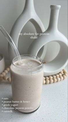 a smoothie in a glass next to two vases on a table with text describing the ingredients