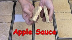 two hands are holding pieces of bread in front of the words apple sauce