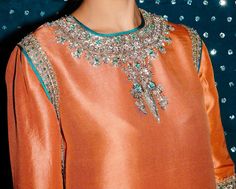 Product Description:  Gorgeous outfit with a shalwar and shorts made of raw silk. Silver Mukesh work, silver naqshi, silver sequins, teal green sequin, silver dabka, and pink buggle beads are used to adorn the shirt's neckline and borders. This outfit looks outstanding thanks to the shalwar's charming border, same-kind embroidery, and embellishments.  Color: Orange Can be customized in any color Includes:  Shirt Pants Duppata Eid Silver Raw Silk Set, Silver Designer Salwar Kameez For Eid, Silver Salwar Kameez With Resham Embroidery For Party, Unstitched Silver Salwar Kameez For Party, Silver Hand Embellished Sharara For Festive Occasions, Silver Embellished Sets For Eid, Festive Silver Hand Embellished Sharara, Embellished Silver Sets For Eid, Silver Kurta With Resham Embroidery For Party