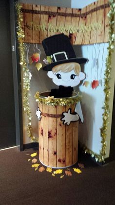 a wooden barrel with an image of a boy in a top hat sitting on it