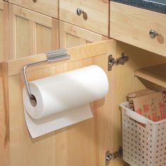 a magazine cover with a roll of toilet paper hanging on the wall and a basket in front of it