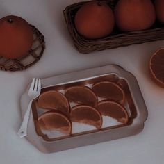 some oranges are sitting on a white table