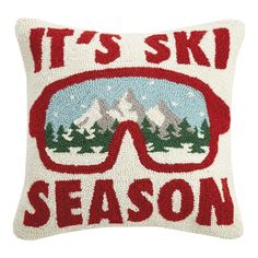 it's ski season pillow with red glasses on the front and snow covered mountains in the background