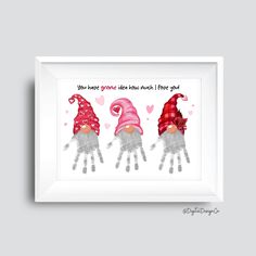 three gnomes with pink hats and hearts on their hands are shown in a white frame