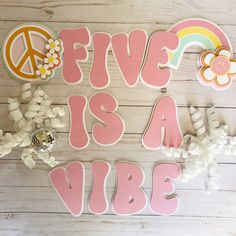 a wooden sign that says, five is a vibe with flowers and peace signs on it