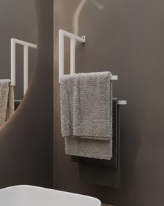 two towels hanging on a towel rack in a bathroom