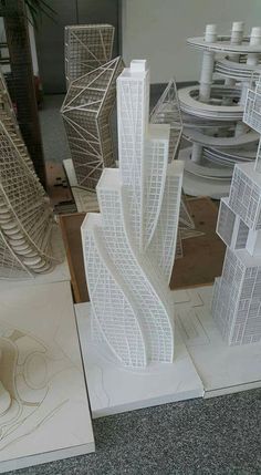 some very tall white buildings in a room