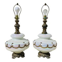 a pair of white lamps sitting on top of each other