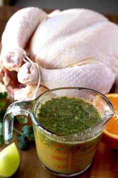 a turkey is in a measuring cup next to an orange and cilantro garnish