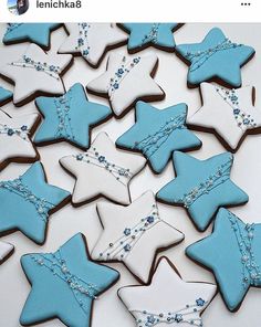 decorated cookies in blue and white are arranged on a table with the words lenichka8 above them