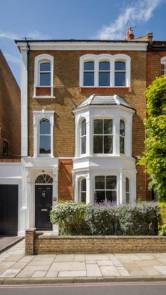 a large brick house with white trim and windows