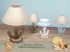 there are three lamps and two seashells on the table next to each other