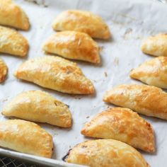 baked pastries on a baking sheet ready to be cooked in the oven for consumption