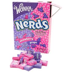 a box of nerds sitting on top of a pile of pink candies in front of a white background