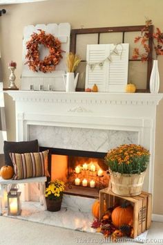 a living room with a fire place filled with pumpkins and other fall decorations on the mantle