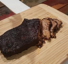 a large piece of meat sitting on top of a wooden cutting board