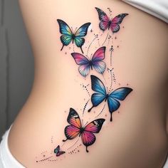 a woman's stomach with colorful butterflies on the side and behind her are tattoos