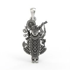 This 925 Sterling Silver Shrinathji Pendant is a beautifully handcrafted devotional piece, perfect for those who cherish their faith and the timeless legend of Shrinathji. According to the legend, the icon of Shrinathji self-manifested from stone and emerged from the Govardhan Hill. Historically, Shrinathji was first worshipped at Govardhan hill near Mathura. To protect it from the Mughal ruler Aurangzeb, the image was moved south on a chariot. When it reached the village of Sinhad in Mewar, the Spiritual Oxidized Temple Necklace, Spiritual Oxidized Temple Necklace As Gift, Spiritual Oxidized Finish Temple Necklace As Gift, Spiritual Silver Temple Necklace For Navratri, Spiritual Oxidized Necklace For Navratri, Silver Spiritual Temple Necklace For Puja, Oxidized Temple Necklace For Navratri Gift, Spiritual Silver Temple Necklace For Rituals, Silver Oxidized Temple Necklace For Puja