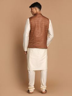 VASTRAMAY Men's Coffee Brown Nehru Jacket With Cream Solid Kurta And Pyjama Set This stylish men's coffee brown Nehru jacket paired with a cream solid kurta and pyjama set offers a classic yet contemporary look suitable for various occasions. Key Features: Includes a coffee brown Nehru jacket Cream solid kurta with intricate detailing Matching pyjama for a complete ensemble Comfortable and stylish design Specifications: Brand: VASTRAMAY Color: Coffee Brown, Cream Material: Cotton Blend Size: Ava Formal Brown Festive Kurta, Festive Brown Formal Kurta, Formal Long Sleeve Brown Kurta, Brown Fitted Nehru Jacket For Winter, Brown Formal Sets For Festive Occasions, Formal Brown Sets For Festive Season, Formal Brown Festive Sets, Festive Formal Brown Sets, Traditional Brown Kurta For Transitional Season