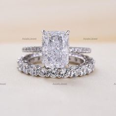 an oval cut diamond ring with two rows of diamonds on each band and the center stone is