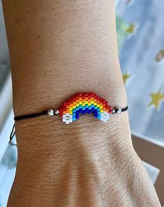 a woman's arm with a bracelet made out of legos