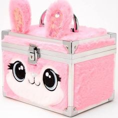 a pink suitcase with two bunny ears on the front and one eye opened to show it's inside