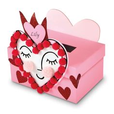 a pink box with a heart shaped decoration in it