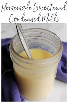 homemade sweetened condensed milk in a mason jar with a spoon and blue napkin on the side