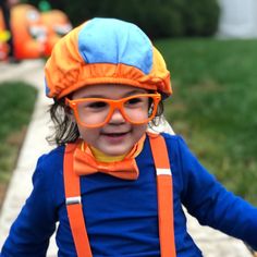 a young child wearing goggles and an orange hat