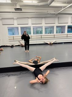 two women are doing exercises in a dance studio