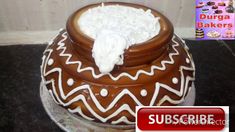 a chocolate cake with white icing and whipped cream on top