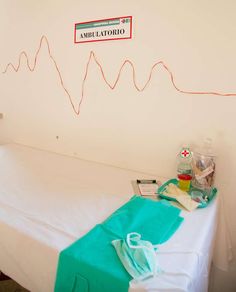 a hospital room with a bed and medical supplies on the table in front of it