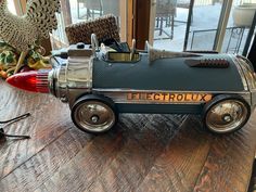 a toy car sitting on top of a wooden table