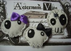 three little stuffed animals with purple bows on them