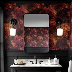 a bathroom with floral wallpaper and two sinks in front of a large mirror above the sink