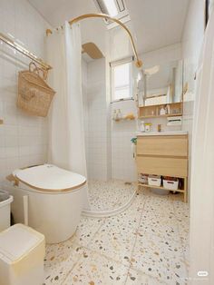 a bathroom with a toilet, sink and bathtub next to a shower curtain in it