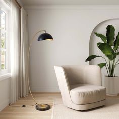 a living room with a chair, lamp and potted plant